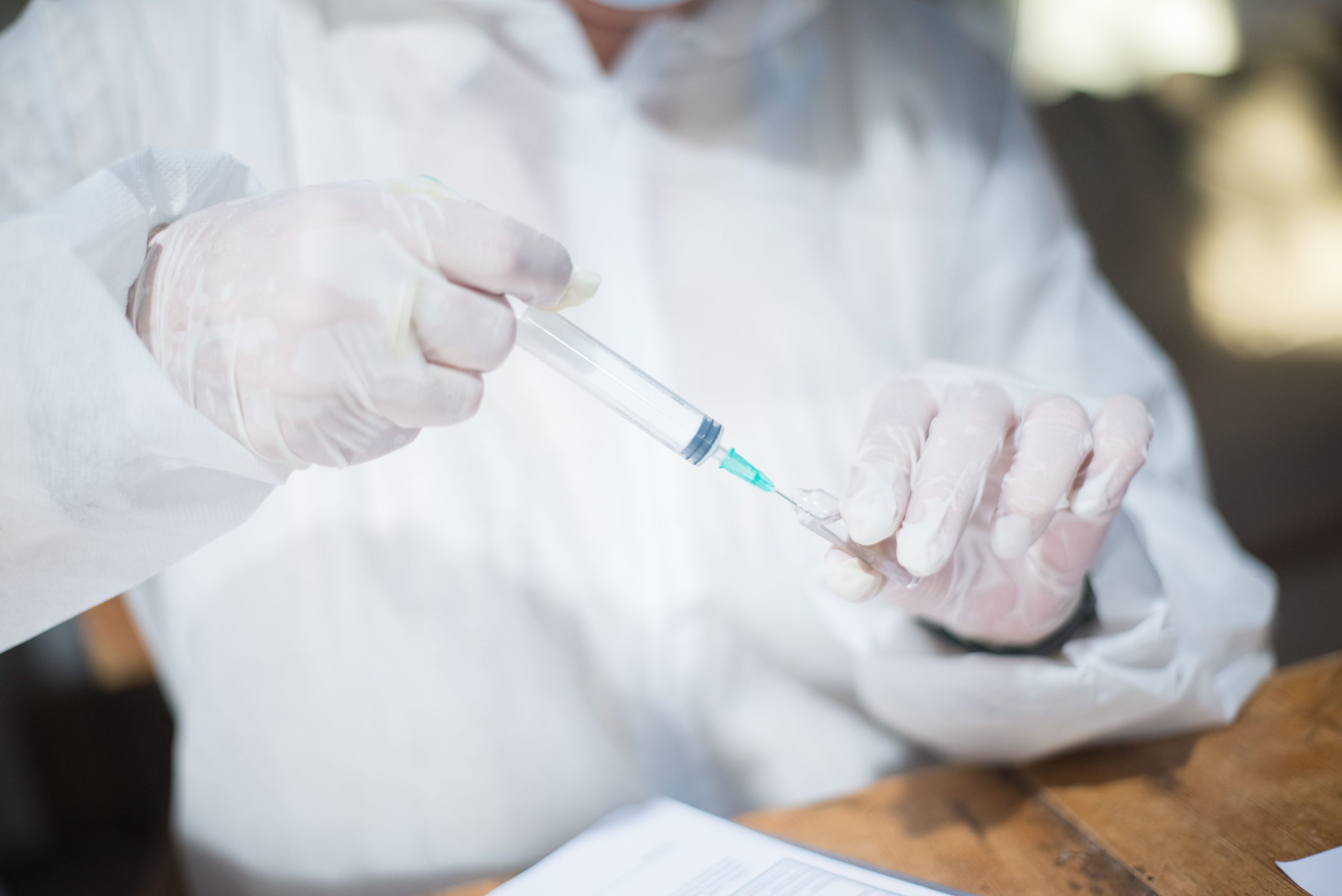 Ebola vaccine vial,Gamaleya Institute laboratory,scientist in lab coat,medical syringe close-up,Africa outbreak hospital